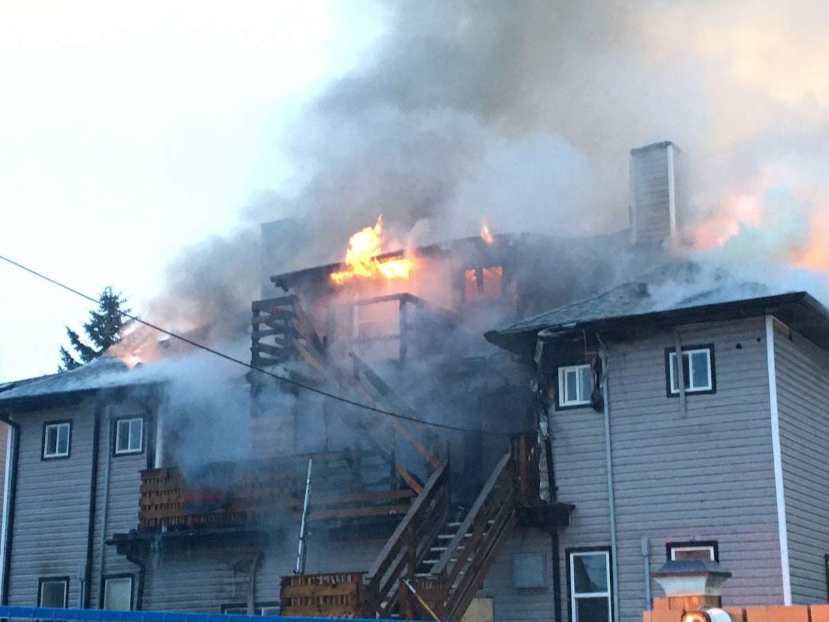 Edmonton Fire Rescue Services crews working to contain a house fire at at 110 Avenue and 123 Street in west-central Edmonton's Westmount neighbourhood. Thursday, March 12, 2020.
