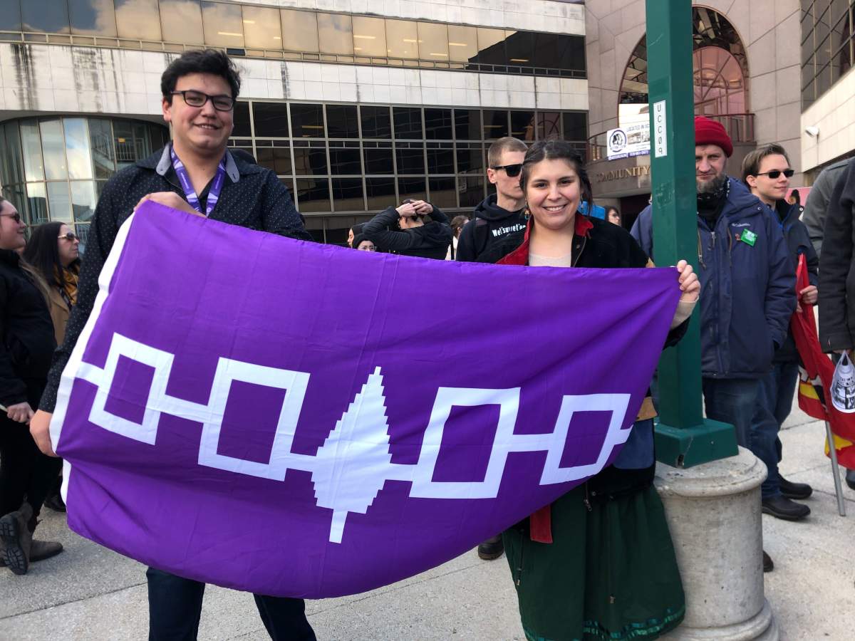 Western University walkout co-organizers Riley Kennedy and Serena Mendizabal holding the Haudenosaunee flag.