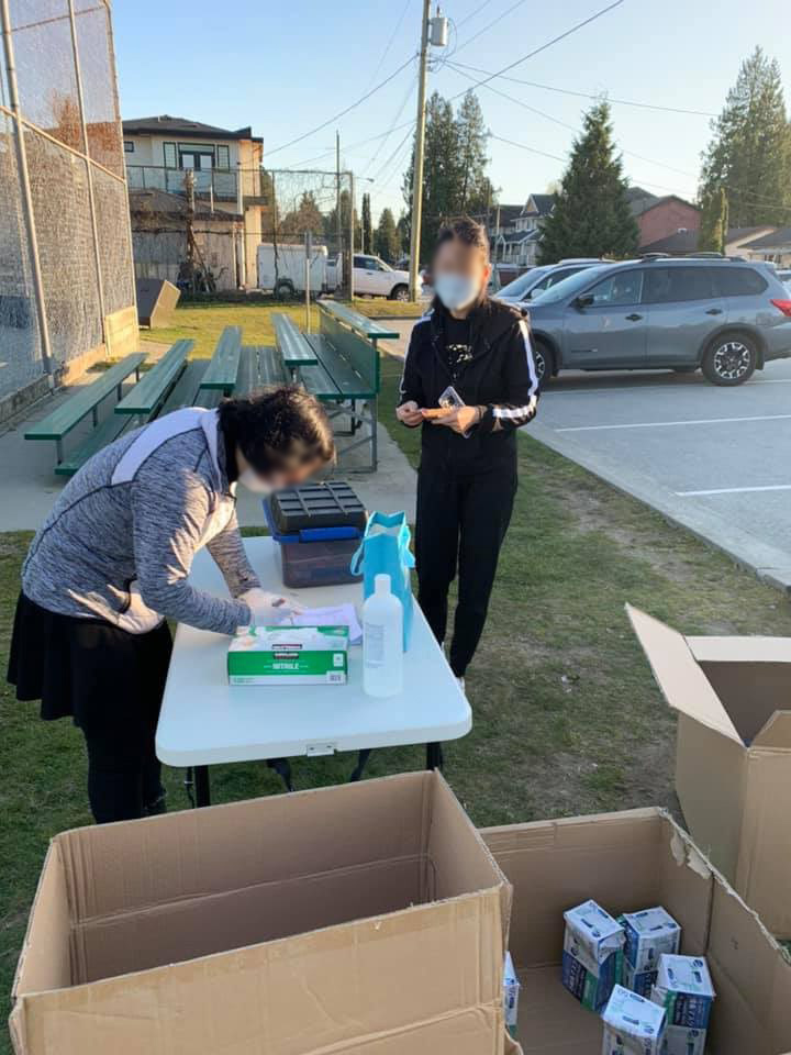 A family sells medical masks in a Port Coquitlam park on March 20, 2020.