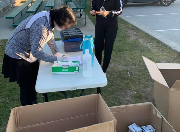 A family sells medical masks in a Port Coquitlam park on March 20, 2020.