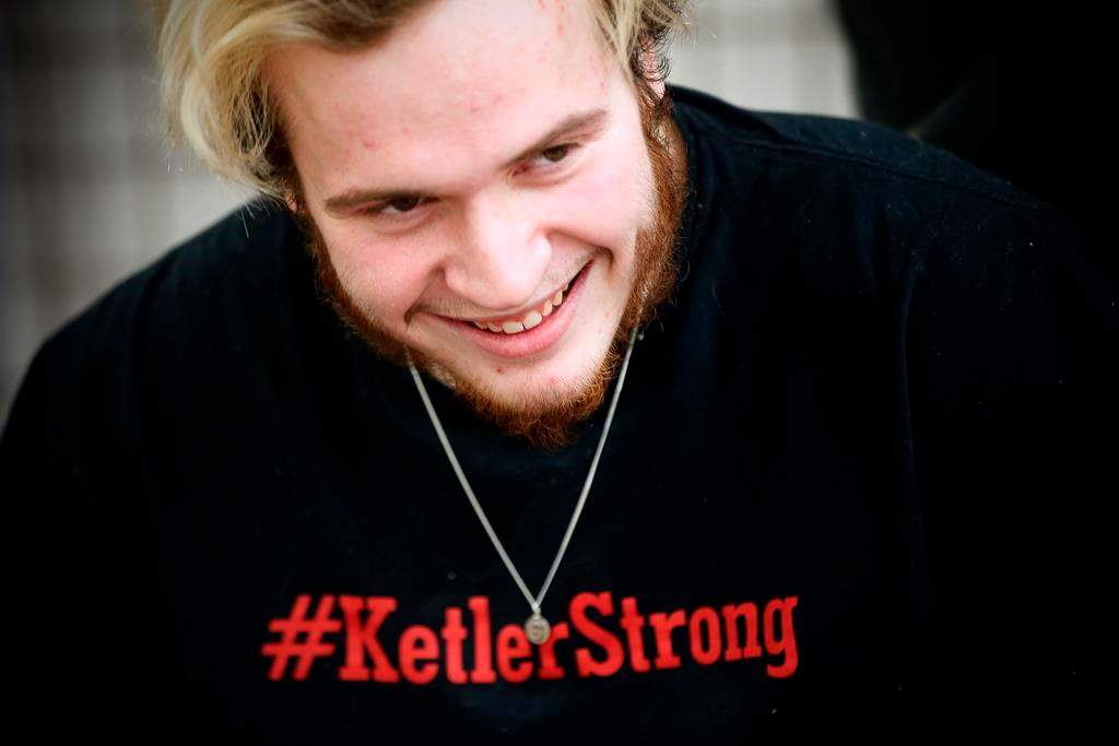 Reese Ketler, a 19-year-old who was paralyzed during a hockey game in December, wears a necklace with his jersey number and a t-shirt with his hashtag as works through his rehabilitation with physiotherapist Kevin Stewart at the Health Sciences Centre in Winnipeg, Thursday, March 5, 2020.