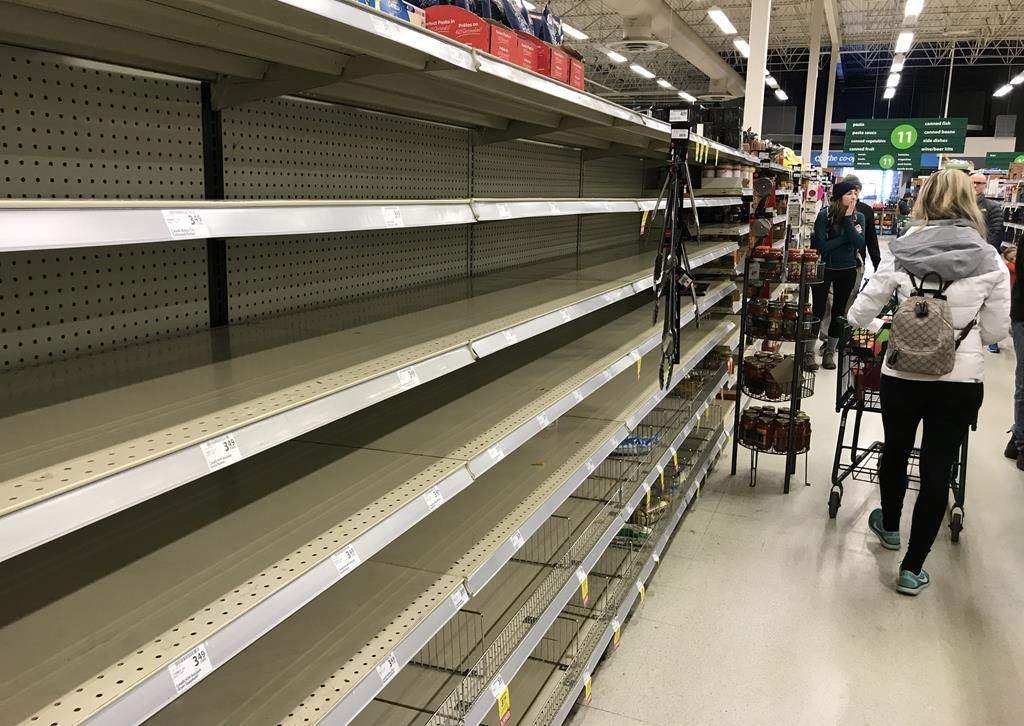 Near empty shelves are pictured at a grocery store in North Vancouver, B.C. Saturday, March 14, 2020. THE CANADIAN PRESS/Jonathan Hayward.