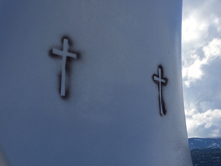 A close-up photo of Kelowna’s iconic Sails sculpture showing two of crosses that were spray painted on the popular attraction.