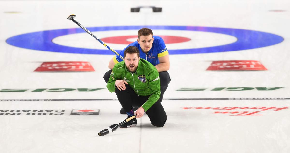 Team Saskatchewan skip Matt Dunstone calls sweep as Team Alberta second Brad Thiessen looks on during a playoff at the Brier in Kingston, Ont., on Saturday, March 7, 2020.
