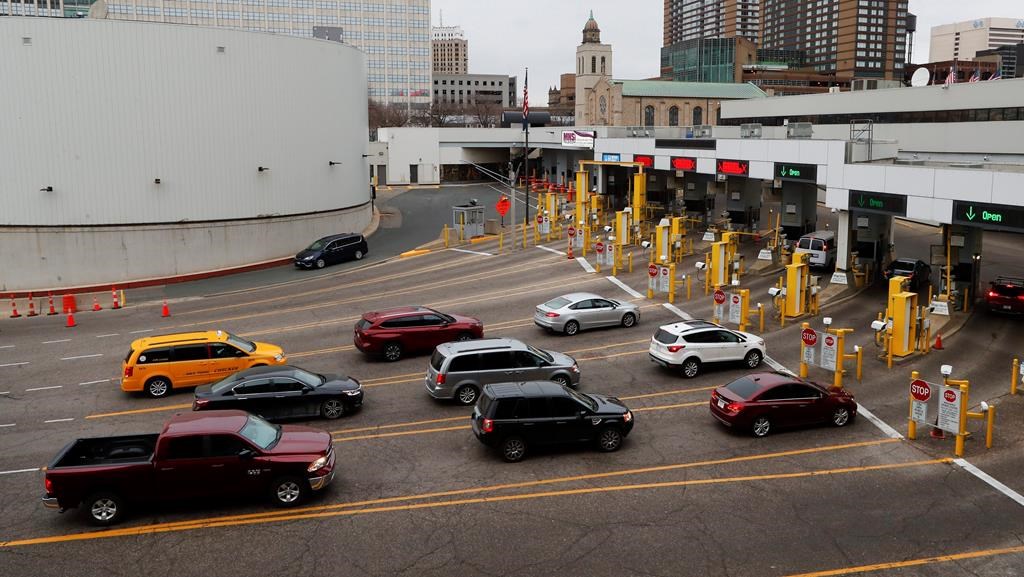 Vehicles enter the United States as a minivan drives to Canada in the Detroit-Windsor Tunnel in Detroit, Monday, March 16, 2020.