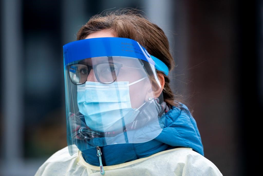 A health-care worker arrives at a walk-in COVID-19 test clinic in Montreal on Monday, March 23, 2020.