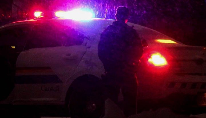 Heavily-armed police officers respond to a robbery in Moncton, N.B., on March 2, 2020. 