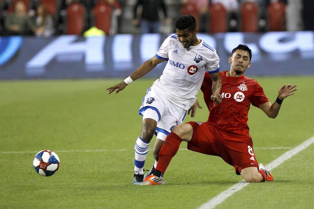 FILE: Montreal Impact midfielder Shamit Shome (28) and Toronto FC midfielder Marco Delgado (8) vie for the ball in the second half of the second leg of Canadian Champion soccer action in Toronto, Wednesday, Sept. 25, 2019. Shome is trying to make the most of his time while hunkered at home during the MLS COVID-19 hiatus. THE CANADIAN PRESS/Cole Burston.