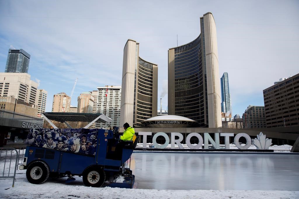 A Toronto city worker operates a Zamboni on the skating rink outside of Toronto City Hall on Saturday, Feb. 29, 2020.