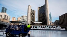 A Toronto city worker operates a Zamboni on the skating rink outside of Toronto City Hall