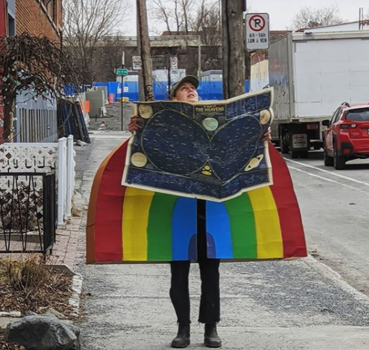 A woman donning a giant rainbow costume has sparked the joy and curosity of Montrealers.