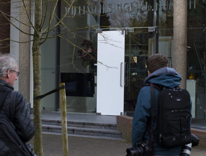 Journalists look at the damaged glass door of the Singer Museum in Laren, Netherlands, on March 30, 2020, where a Van Gogh painting was stolen.