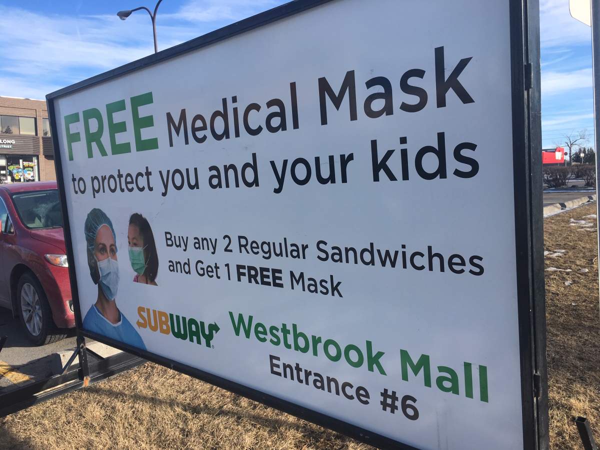 A sign outside Westbrook Mall in Calgary advertised a free medical face mask to customers who bought two sandwiches. 
