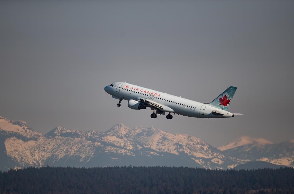 An Air Canada flight departing for Kelowna takes off at Vancouver International Airport, in Richmond, B.C., on March 20, 2020. THE CANADIAN PRESS/Darryl Dyck.