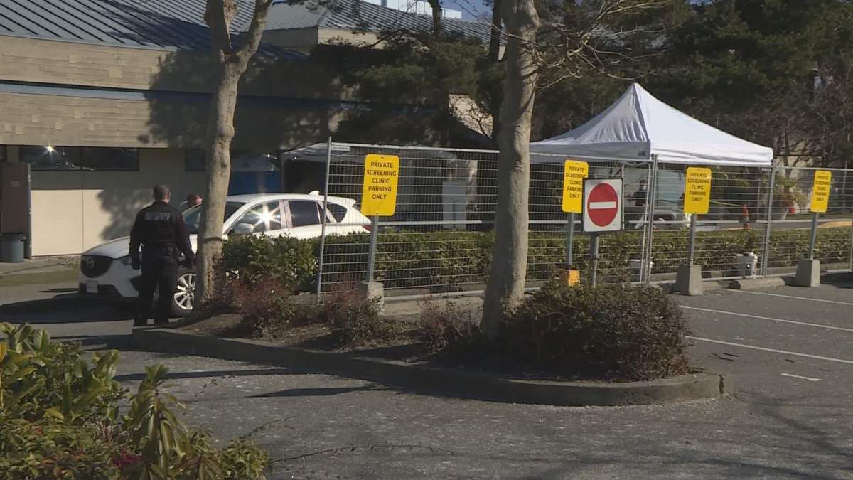 A vehicle goes through a drive-thru COVID-19 test station in Victoria on Monday, March 16, 2020. 