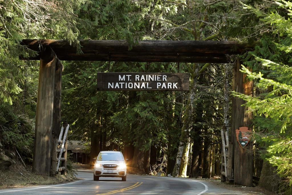 A car passes through the entrance to Mount Rainier National Park, Wednesday, March 18, 2020, in Washington state.