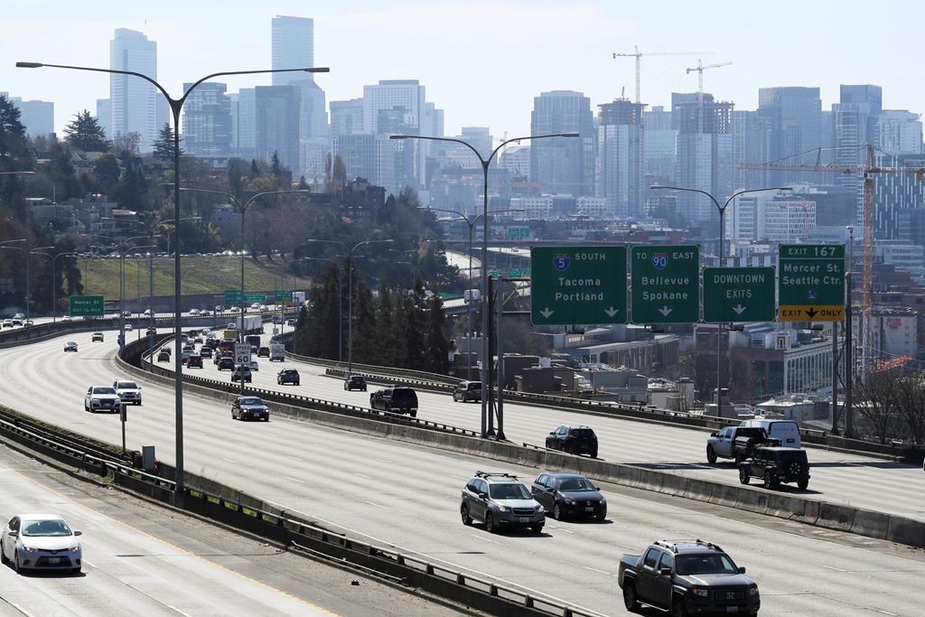 Early afternoon traffic is thin on Interstate 5 north of downtown Seattle, Friday, March 20, 2020. With many people working from home or otherwise not traveling, Seattle's notorious traffic has been minimal during the outbreak of the new coronavirus.