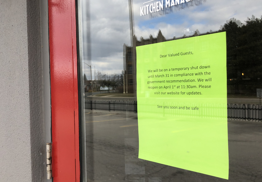 A shutdown notice posted on the door of Ye Olde Squire on Main Street West in Hamilton on March 17, 2020.
