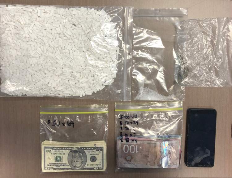 A vehicle search found thousands of pills, the counterfeit cash, which was both Canadian and U.S. currency, and a small amount of methamphetamine.