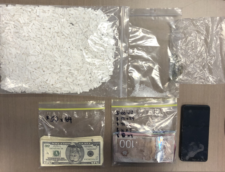 A vehicle search found thousands of pills, the counterfeit cash, which was both Canadian and U.S. currency, and a small amount of methamphetamine.