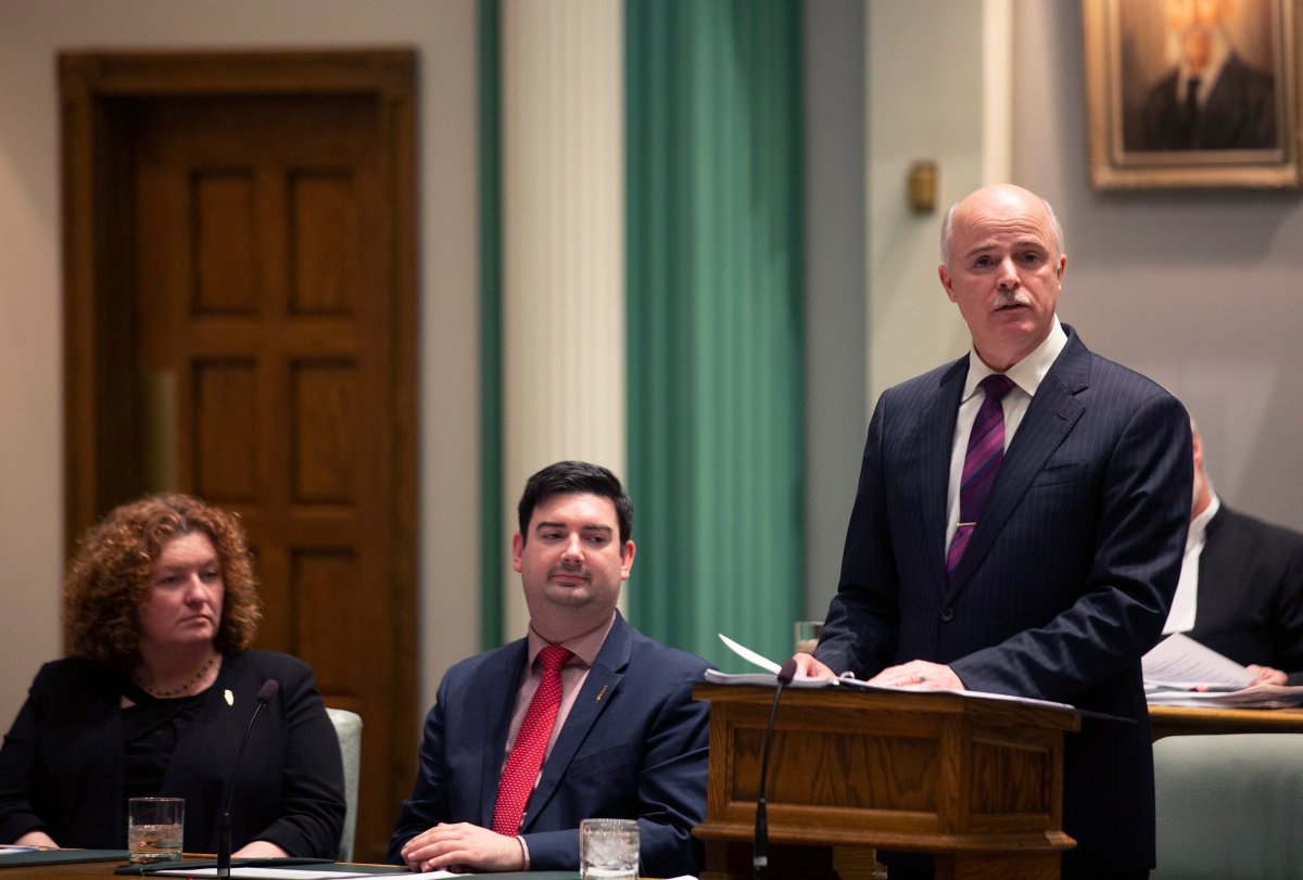 Sherry Gambin-Walsh, minister of service, left to right, and Christopher Mitchelmore, minister of tourism, culture and innovation listen as Finance Minister Tom Osborne presents the 2019 Budget in the House of Assembly in St. John's on April 16, 2019. 