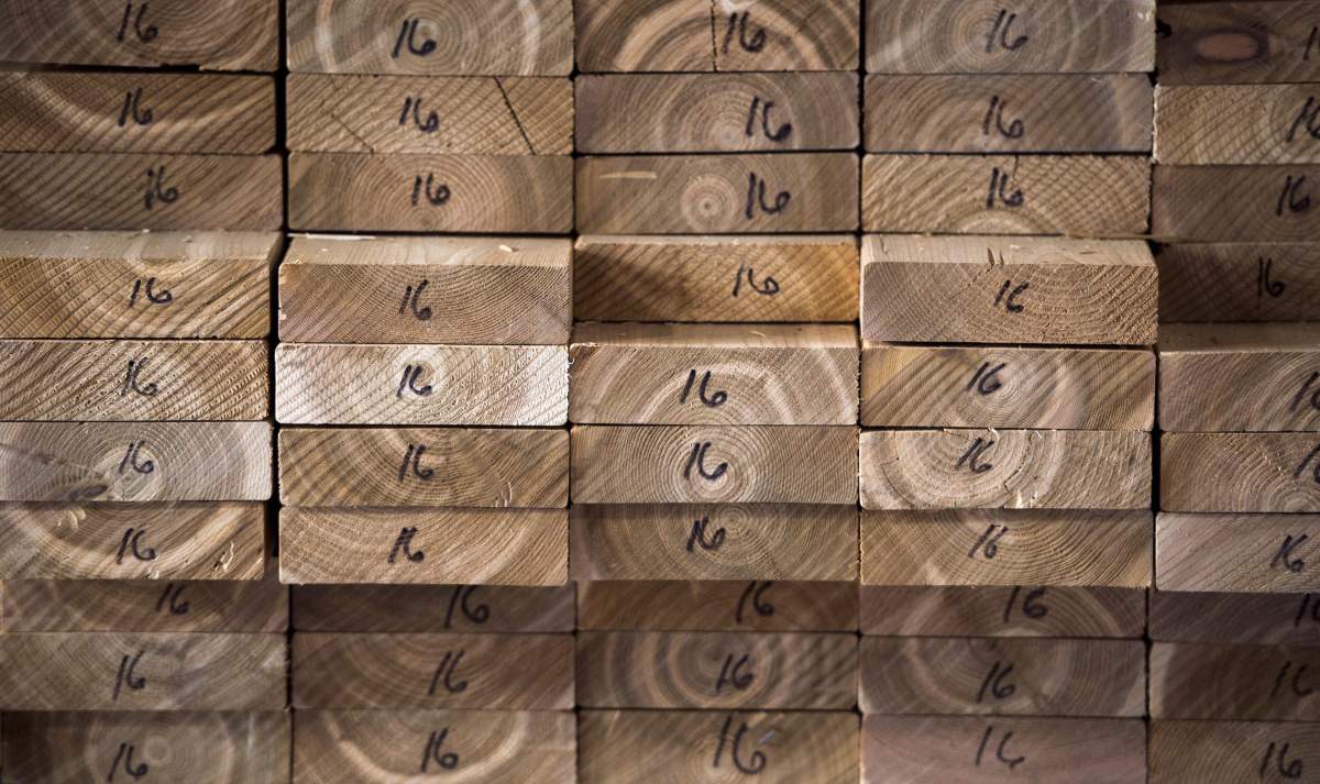 Cedar planks are stacked at a lumber yard in Montreal, Tuesday, April 25, 2017. Resolute Forest Products Inc. says it's laying off more than 1,000 people.
