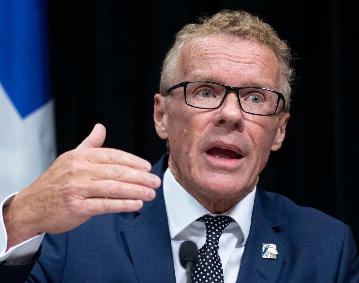 Quebec Labour, Employment and Social Solidarity Jean Boulet responds to reporters questions during a news conference.