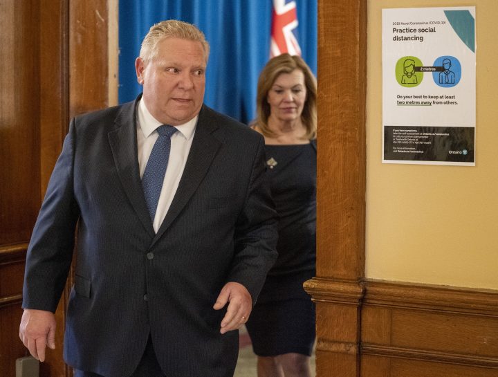 Ontario Premier Doug Ford and Health Minister Christine Elliott exit the daily briefing at Queen's Park in Toronto on Tuesday March 31, 2020. 