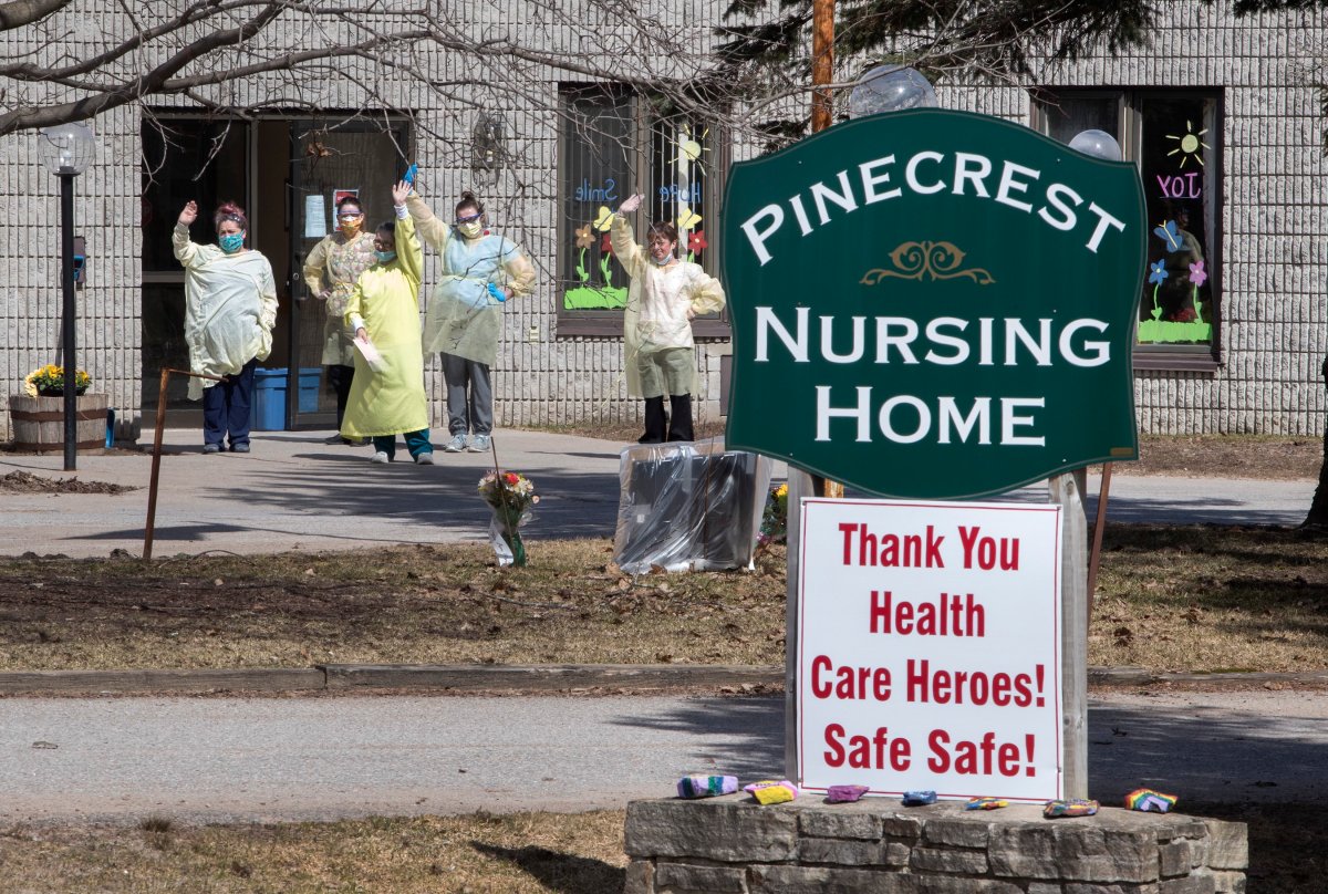 Nurses wave to hundreds of residents driving by Pinecrest Nursing Home honking their horns to acknowledge health-care workers in Bobcaygeon, Ont., on Wednesday, April 1.