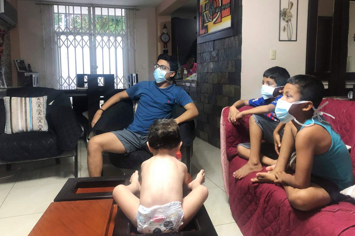 In this March 26, 2020, photo, relatives of Bella Lamilla the first person to be diagnosed with coronavirus in Ecuador, maintain quarantine in their home in Babahoyo, Ecuador.