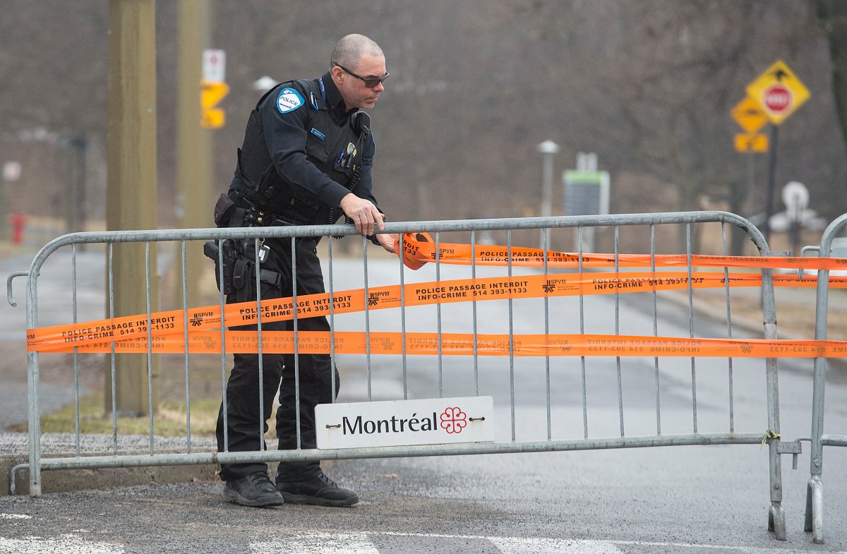 A Police officer tapes up the entrance to a parking lot in Mount Royal park Montreal, Sunday, April 5, 2020, as Coronavirus COVID-19 cases rise in Canada and around the world. The city of Montreal has closed parking lots in some city parks to help stop the spread of COVID-19. 