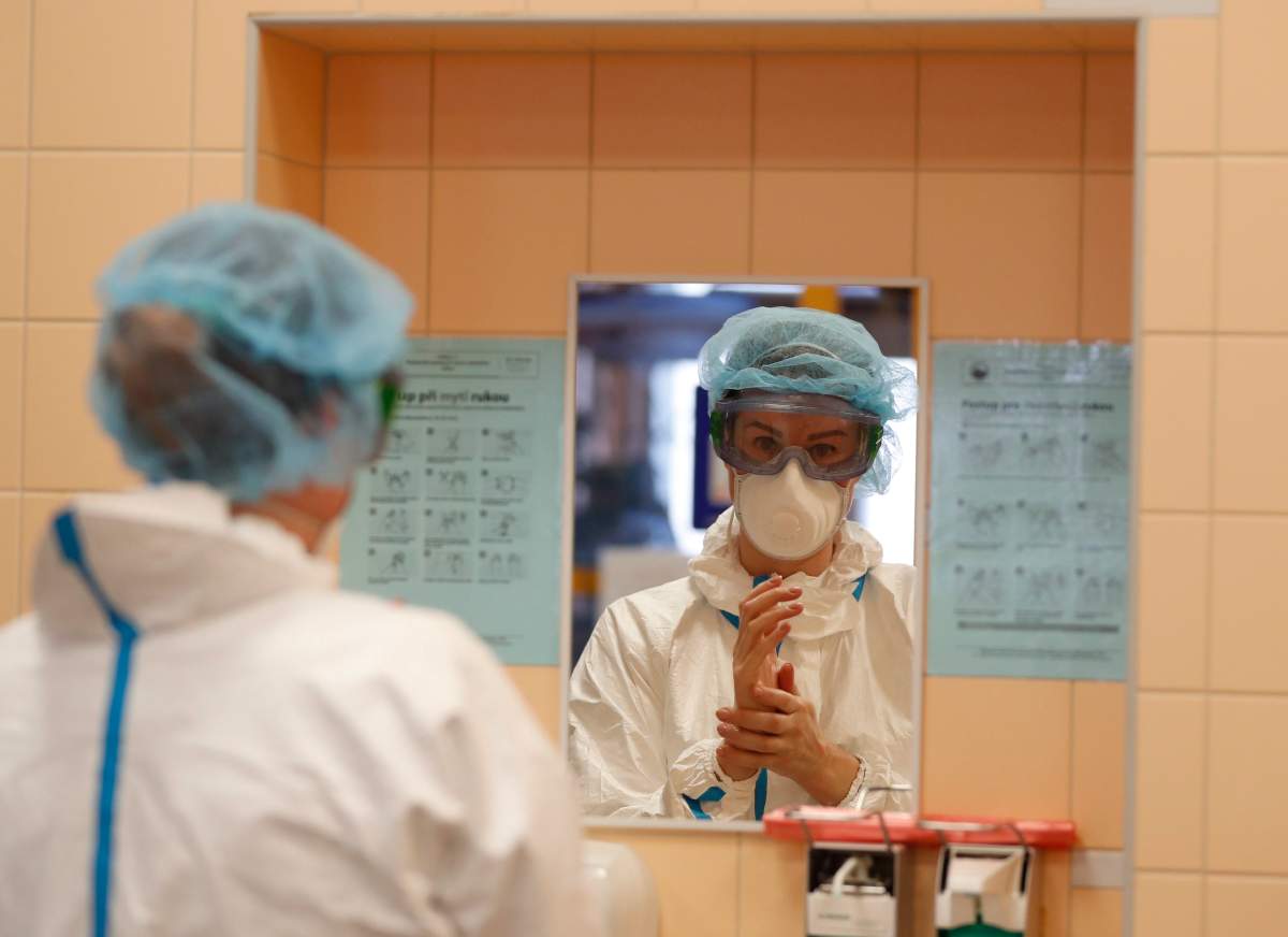 A healthcare worker washes her hands during her shift at an intensive care unit (ICU) at the General University Hospital where patients infected with the COVID-19 are treated in Prague, Czech Republic, Tuesday, April 7, 2020.