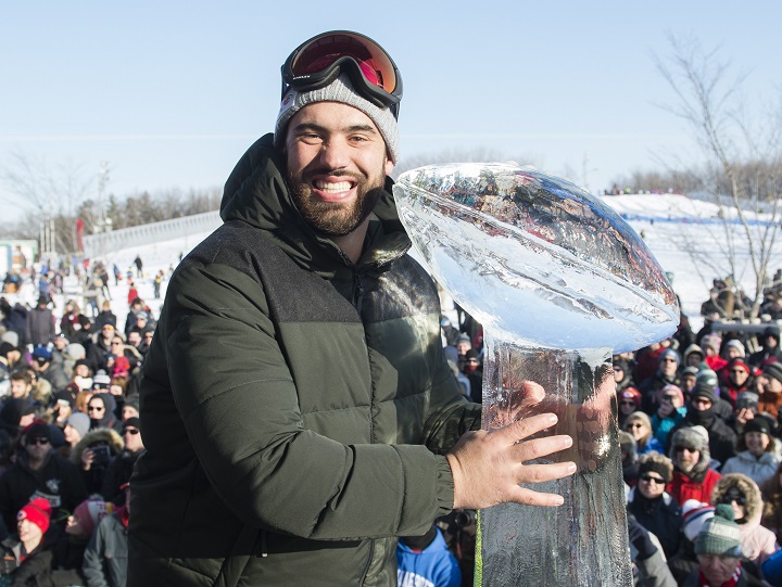 Super Bowl champion and Kansas City Chiefs player Laurent Duvernay-Tardif poses next to an ice sculpture of the Vince Lombardi trophy during an event to celebrate his win in Montreal, Sunday, February 9, 2020. It's certainly been a different off-season for Canadian guard Duvernay-Tardif, once basking in the glory of the Chiefs' Super Bowl victory and now dealing with the challenges and uncertainty presented by the COVID-19 pandemic. 