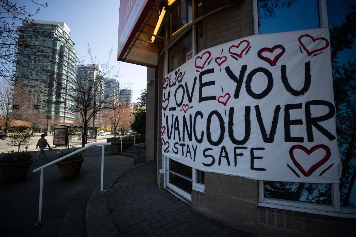A banner with a message is hung on the front of a closed bike rental business in Vancouver, on Thursday, April 16, 2020. 