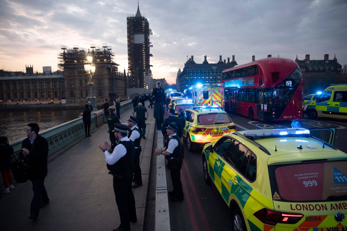 London Ambulance staff, police officers and firefighters take part in the weekly "clap for our carers" as they stand on Westminster Bridge backdropped by a scaffolded Big Ben and the Houses of Parliament in London, during the lockdown to try and stop the spread of coronavirus, Thursday, April 16, 2020. The applause takes place across Britain every Thursday at 8pm local time to show appreciation for healthcare workers, emergency services, armed services, delivery drivers, shop workers, teachers, waste collectors, manufacturers, postal workers, cleaners, vets, engineers and all those helping people with coronavirus and keeping the country functioning while most people stay at home in the lockdown. (AP Photo/Matt Dunham).