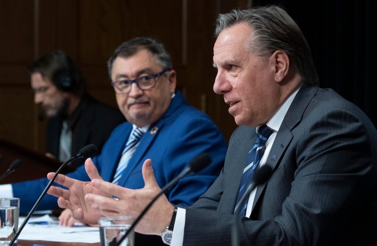 In this file photo, Quebec Premier François Legault speaks during a news conference on the COVID-19 pandemic, Wednesday, April 22, 2020 at the legislature in Quebec City while Horacio Arruda, Quebec director of national public health, left, looks on.