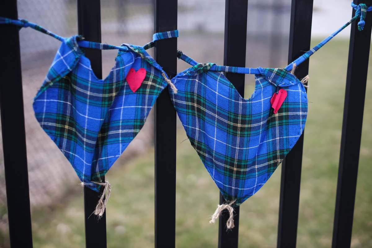 Hearts made of the Nova Scotia tartan are shown at a makeshift shrine honouring Const. Heidi Stevenson, victim of N.S. shooting, outside RCMP headquarters in Dartmouth, N.S., Friday, April 24, 2020.