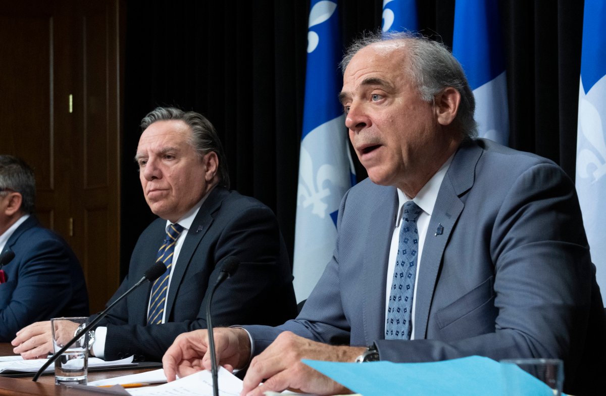 Quebec Economy and Innovation Minister Pierre Fitzgibbon outlines the rules for a reopening of some commercial activities during a news conference on the COVID-19 pandemic, Tuesday, April 28, 2020 at the legislature in Quebec City. Quebec Premier Francois Legault, left, looks on. 