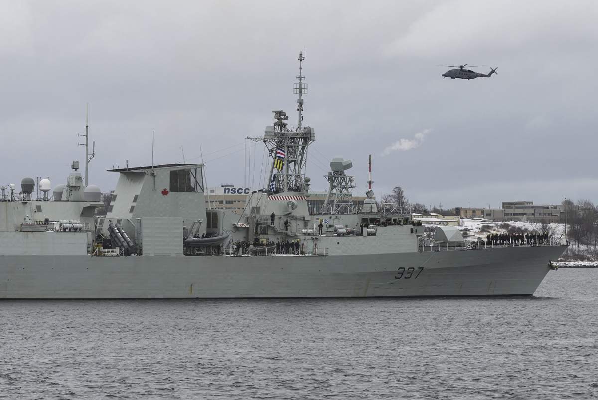 A Cyclone helicopter flies over HMCS Fredericton as its crew leaves the Halifax Harbour for a six-month deployment to the Mediterranean Sea as part of NATO’s Operation Reassurance in Halifax on Monday, Jan. 20, 2020. (THE CANADIAN PRESS/Darren Calabrese)