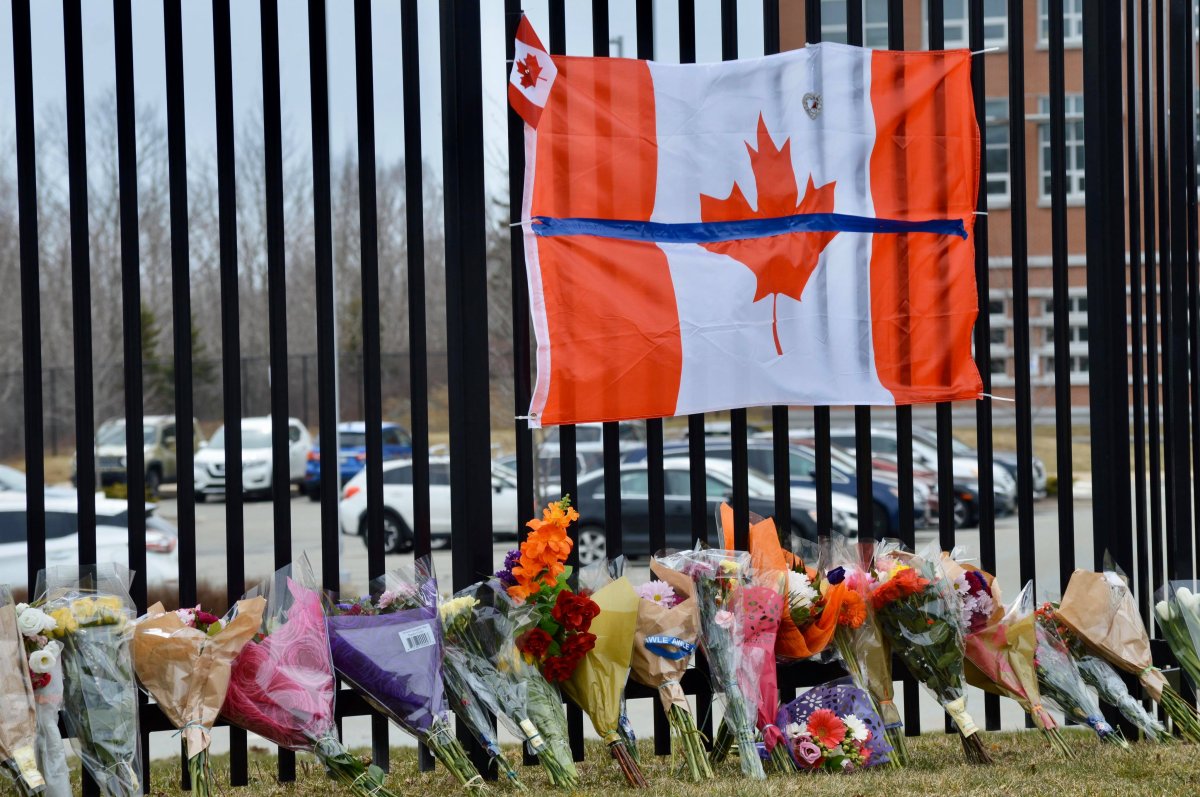 Flowers, gifts and a Canadian flag rest at the memorial to Corp. Heidi Stevenson at the RCMP Headquarters in Burnside, N.S., on April 20, 2020. 