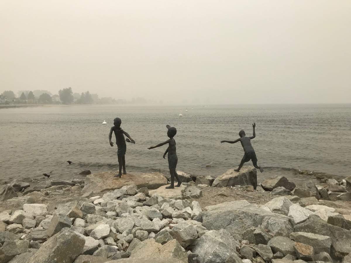 A statue of children playing is seen amid haze in Penticton on Sept. 14.