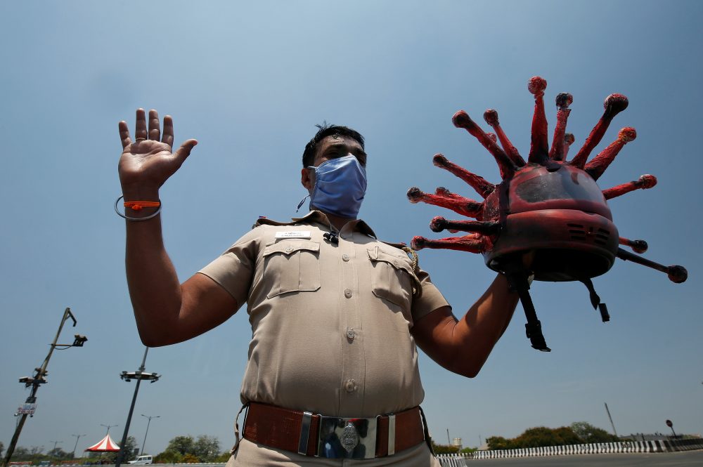 Rajesh Babu is shown holding his coronavirus helmet in Chennai, India, on March 28, 2020.