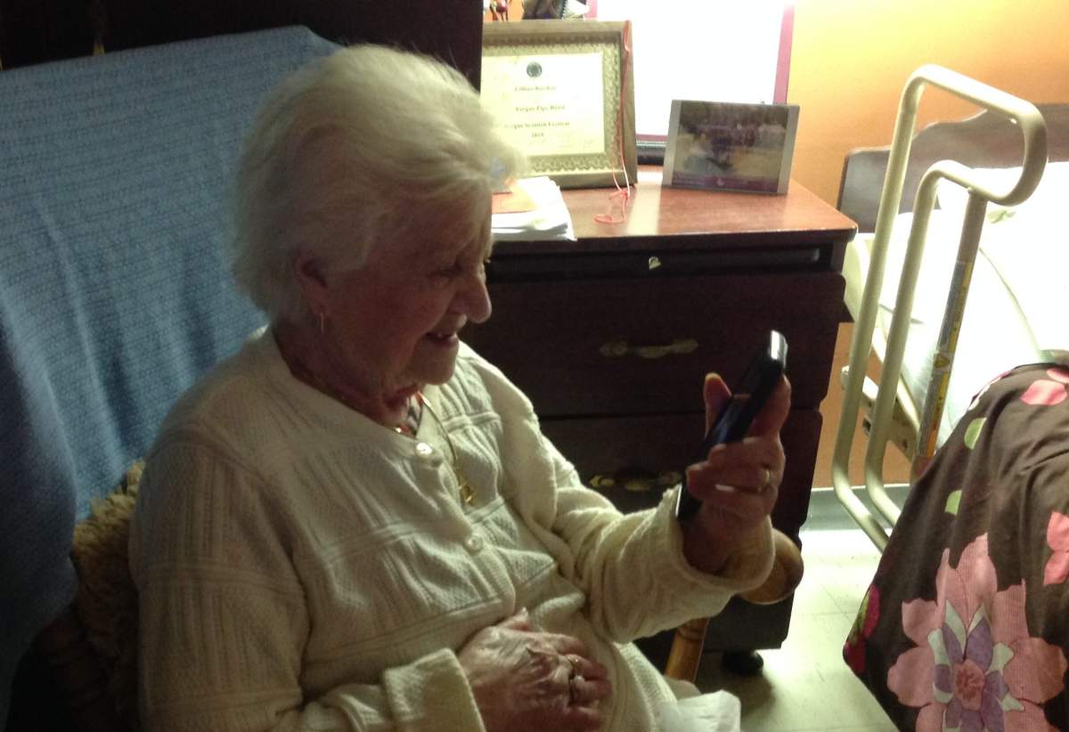 Lilian Burden smiles at a video made by her granddaughter.