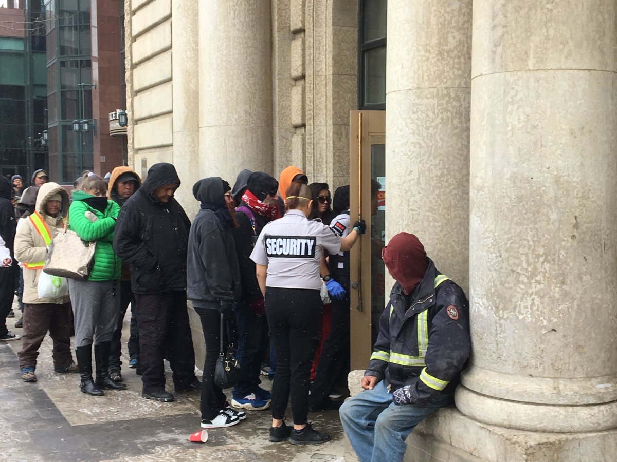 Patrons lining up outside a CIBC location on Jasper Avenue in Edmonton on April 1, 2020. 