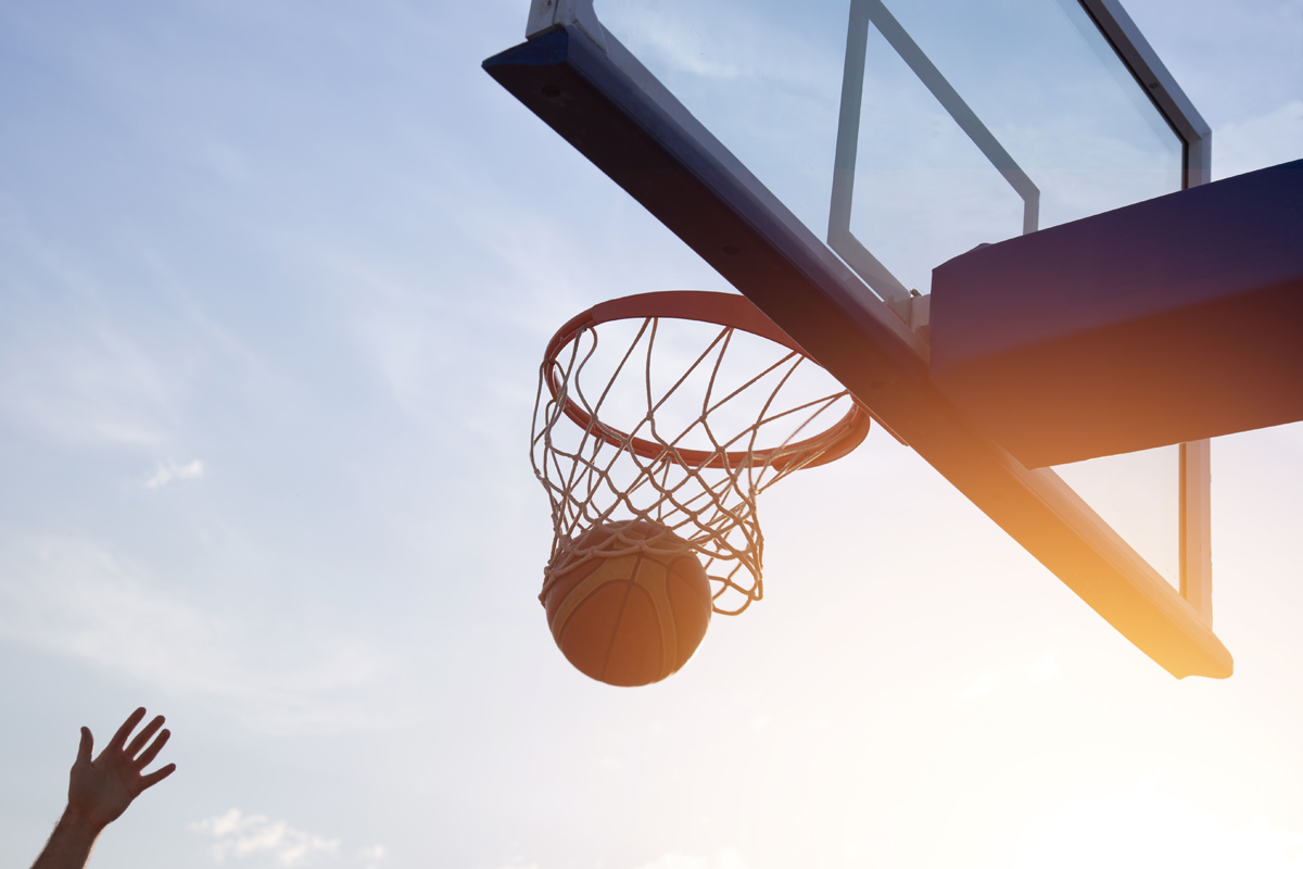 Basketball going through the basket.