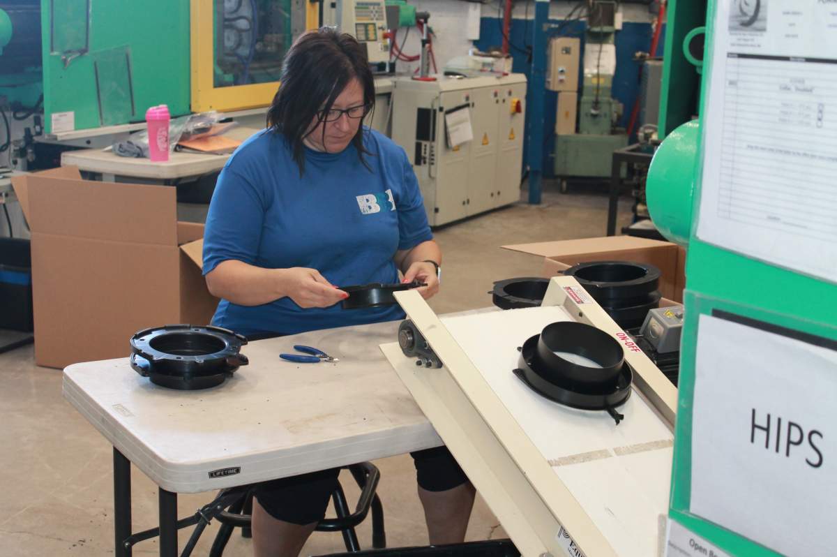 A Bouctouche Bay Indutries employee works on the raw materials for a protective face mask in Saint Edouard de Kent, N.B. in April 2020. The company is one of thousands that have pivoted their business model to meet the demands of the COVID-19 pandemic.