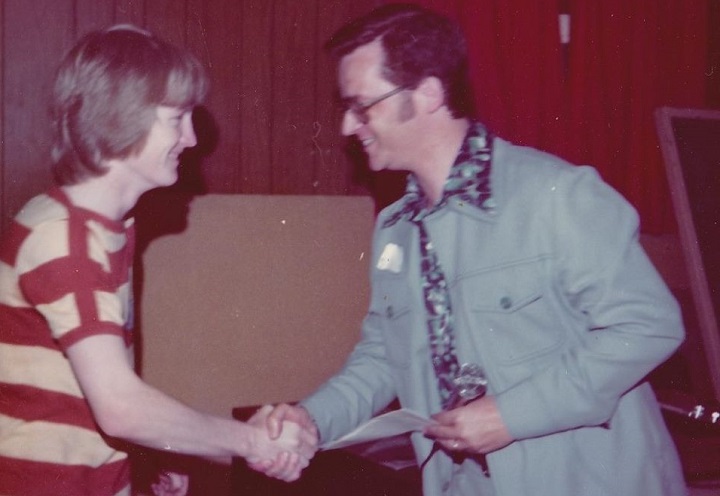Bob Layton awards a student with his certificate at the Bob Layton School of Broadcasting in the mid-1970s.