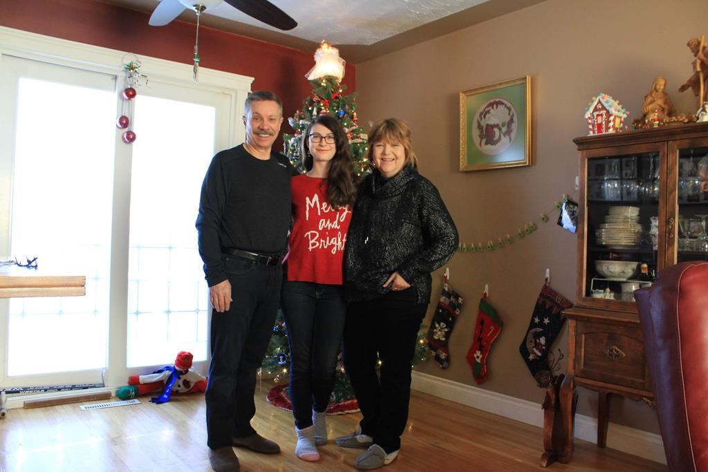 Deb Diemer, 57, right, poses for a photo with her husband Mike Diemer and her daughter 18-year-old daughter Helena in this handout image in Calgary.