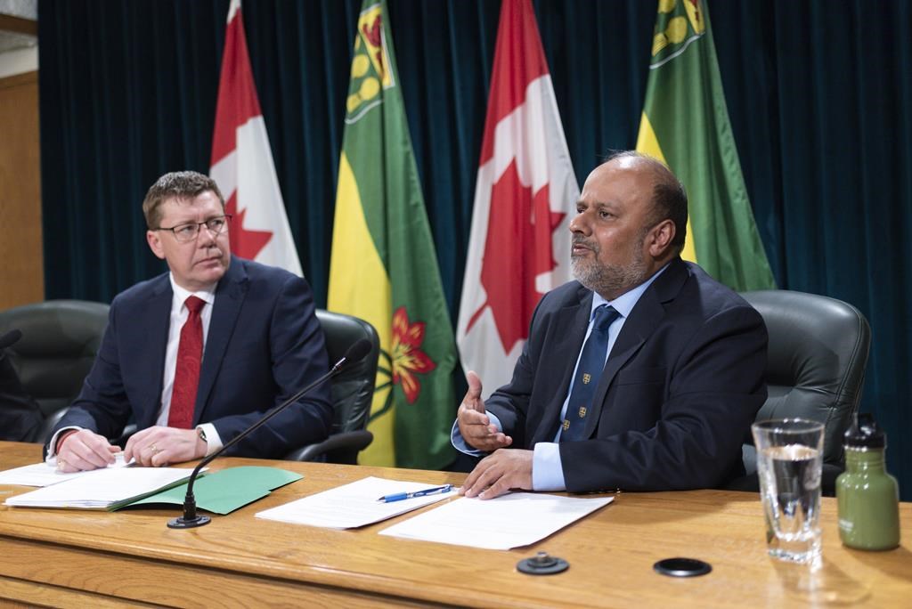 Saqib Shahab, chief medical health officer, right, speaks while Saskatchewan Premier Scott Moe looks on at a COVID-19 news update at the Legislative Building in Regina on Wednesday, March 18, 2020.