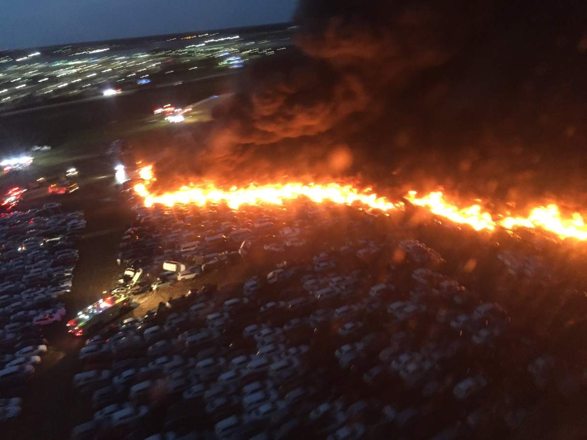 This aerial photo shows fire crews fighting to stop a blaze from destroying rental cars at the Southwest Florida International Airport on Apr. 3, 2020.